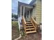 Wooden steps leading to a porch of a green house at 1777 Yellow Nw St, Conyers, GA 30012