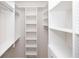 Spacious walk-in closet with hanging rods and shelves at 550 Fisher Dr # 47, Alpharetta, GA 30009