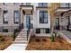 Beautiful exterior of a brick townhome featuring a blue door, black windows, and manicured landscaping at 550 Fisher Dr # 47, Alpharetta, GA 30009