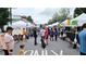 Busy farmers market with various vendors and shoppers at 550 Fisher Dr # 47, Alpharetta, GA 30009