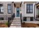 Charming brick home with a welcoming teal front door, black accents, and landscaped front yard at 550 Fisher Dr # 47, Alpharetta, GA 30009