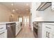 Open concept kitchen with a farmhouse sink, stainless steel appliances, and hardwood floors at 550 Fisher Dr # 47, Alpharetta, GA 30009