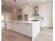 Modern kitchen featuring white cabinetry, a large island, and stainless steel appliances at 550 Fisher Dr # 47, Alpharetta, GA 30009