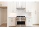 Stainless steel range and oven in a white kitchen with herringbone backsplash at 550 Fisher Dr # 47, Alpharetta, GA 30009