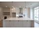 White kitchen with a large island, stainless steel appliances, and globe lighting at 550 Fisher Dr # 47, Alpharetta, GA 30009