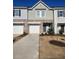 Two-story townhome with attached garage and landscaped front yard at 137 Swindon Dr, Mcdonough, GA 30253