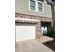 Attached garage with white door and brick facade at 137 Swindon Dr, Mcdonough, GA 30253