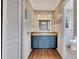 Bathroom with blue vanity, mirror, and built-in shelving at 2500 Cottonwood Dr, Marietta, GA 30066