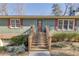 Inviting front entrance with wooden stairs and landscaping at 2500 Cottonwood Dr, Marietta, GA 30066