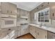 View of updated kitchen with gray cabinets and stainless steel appliances at 2500 Cottonwood Dr, Marietta, GA 30066