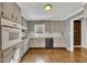 Updated kitchen featuring wood floors, gray cabinets, and stainless steel appliances at 2500 Cottonwood Dr, Marietta, GA 30066