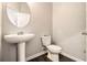 Simple bathroom with pedestal sink and dark floors at 2784 Cypress Rdg, Loganville, GA 30052