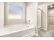 Bright bathroom with soaking tub, glass shower, and access to a walk-in closet at 2784 Cypress Rdg, Loganville, GA 30052