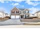 Brick two-story house with a two-car garage, and front yard at 2784 Cypress Rdg, Loganville, GA 30052