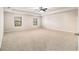 Expansive carpeted Primary bedroom with large windows and a tray ceiling with ceiling fan at 2784 Cypress Rdg, Loganville, GA 30052