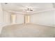 Expansive carpeted Primary bedroom with a tray ceiling and ceiling fan with adjoining bathroom and closet at 2784 Cypress Rdg, Loganville, GA 30052