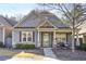 Charming craftsman style home with gray siding, stone accents, and welcoming porch at 340 Glens Way, Woodstock, GA 30188