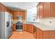 Kitchen with stainless steel appliances and light wood cabinets at 340 Glens Way, Woodstock, GA 30188