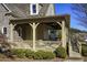 Covered porch with stone details and seating area at 340 Glens Way, Woodstock, GA 30188