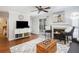 Bright living room with fireplace, hardwood floors, and sliding glass door to patio at 631 Granville Ct, Atlanta, GA 30328