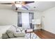 Bright bedroom with hardwood floors, large window, and sitting area at 6900 Roswell Rd, Atlanta, GA 30328