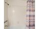 Clean shower and tub area with striped shower curtain at 6900 Roswell Rd, Atlanta, GA 30328