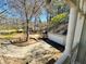 View of a backyard and detached garage from a white trimmed porch at 850 Airline Rd, Mcdonough, GA 30252