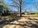 Large backyard with open space, mature trees, and a deck, perfect for outdoor activities at 850 Airline Rd, Mcdonough, GA 30252