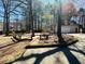 Outdoor patio area with built-in benches, set amidst mature trees and landscaping at 850 Airline Rd, Mcdonough, GA 30252