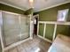 Bathroom with a stand-up shower, olive paint, white trim, and tile floor at 850 Airline Rd, Mcdonough, GA 30252