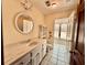 Bright bathroom featuring a white vanity, tile floors, and natural light from large window at 850 Airline Rd, Mcdonough, GA 30252