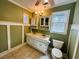 Bathroom with dual vanity, white cabinets, ceramic tile floor, and natural light from window at 850 Airline Rd, Mcdonough, GA 30252