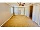 Bedroom with neutral paint, ceiling fan with light, carpet, and two closets at 850 Airline Rd, Mcdonough, GA 30252