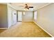 Bedroom featuring a ceiling fan with light, neutral paint, and natural light from windows and door at 850 Airline Rd, Mcdonough, GA 30252