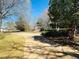 Long driveway leading to a residence, featuring a meticulously maintained lawn and landscaping at 850 Airline Rd, Mcdonough, GA 30252