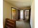 Upstairs hallway with three doors and a wooden bookshelf at 850 Airline Rd, Mcdonough, GA 30252