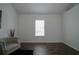 Well-lit bedroom featuring hardwood floors and a window at 12558 Lakeside Pkwy, Fayetteville, GA 30215