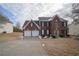 Brick two-story house with attached two-car garage and landscaping at 12558 Lakeside Pkwy, Fayetteville, GA 30215