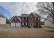 Brick two-story house with a two-car garage at 12558 Lakeside Pkwy, Fayetteville, GA 30215