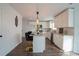 Bright kitchen featuring white cabinets, granite counters, and hardwood floors at 12558 Lakeside Pkwy, Fayetteville, GA 30215