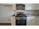 Stainless steel range and microwave in a kitchen with granite countertops at 12558 Lakeside Pkwy, Fayetteville, GA 30215