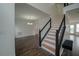 Modern staircase with black railing and dark hardwood floors at 12558 Lakeside Pkwy, Fayetteville, GA 30215