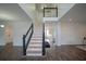 Modern staircase with black railings and dark hardwood floors at 12558 Lakeside Pkwy, Fayetteville, GA 30215