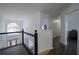 Upstairs hallway with dark hardwood floors and access to bedrooms at 12558 Lakeside Pkwy, Fayetteville, GA 30215