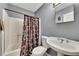 Small basement bathroom with shower/tub combo and pedestal sink at 180 Paces Lakes Pointe St, Dallas, GA 30157