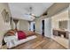 Main bedroom with wood-look floors, ceiling fan, and en-suite bathroom at 180 Paces Lakes Pointe St, Dallas, GA 30157