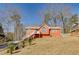 Red siding ranch home with large yard at 180 Paces Lakes Pointe St, Dallas, GA 30157