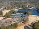 Aerial view highlighting tennis courts and clubhouse near lake at 2585 Club Springs Drive, Roswell, GA 30076