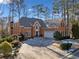 Brick home with a paved driveway and landscaping at 2585 Club Springs Drive, Roswell, GA 30076