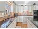 Bright kitchen featuring granite countertops, custom cabinetry, and hardwood floors at 2585 Club Springs Drive, Roswell, GA 30076